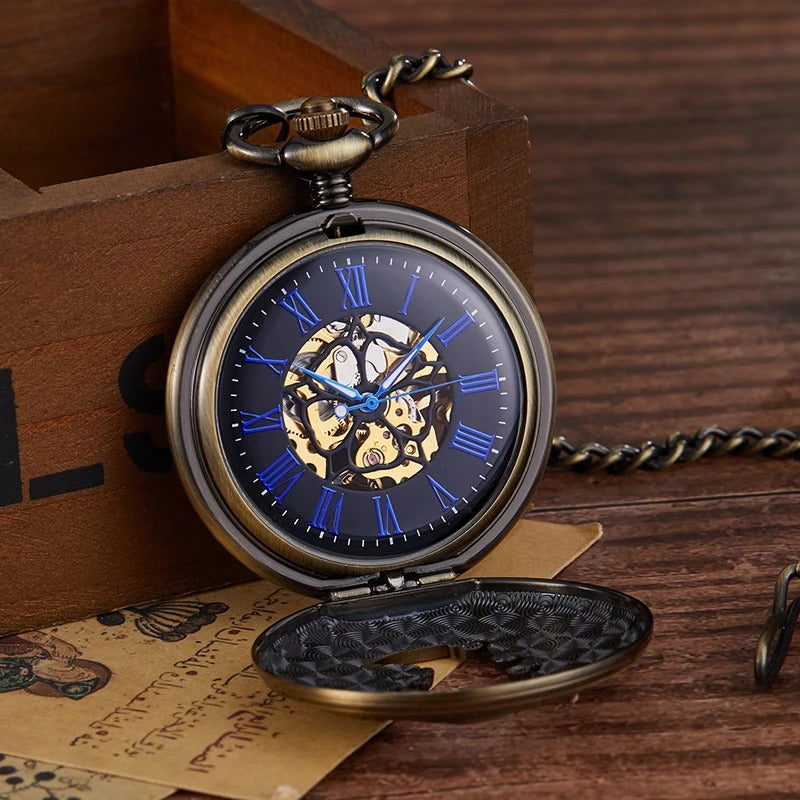 Montre à gousset ouverte : cadran noir à chiffres romains bleus et mouvement mécanique squelette apparent, boîtier bronze